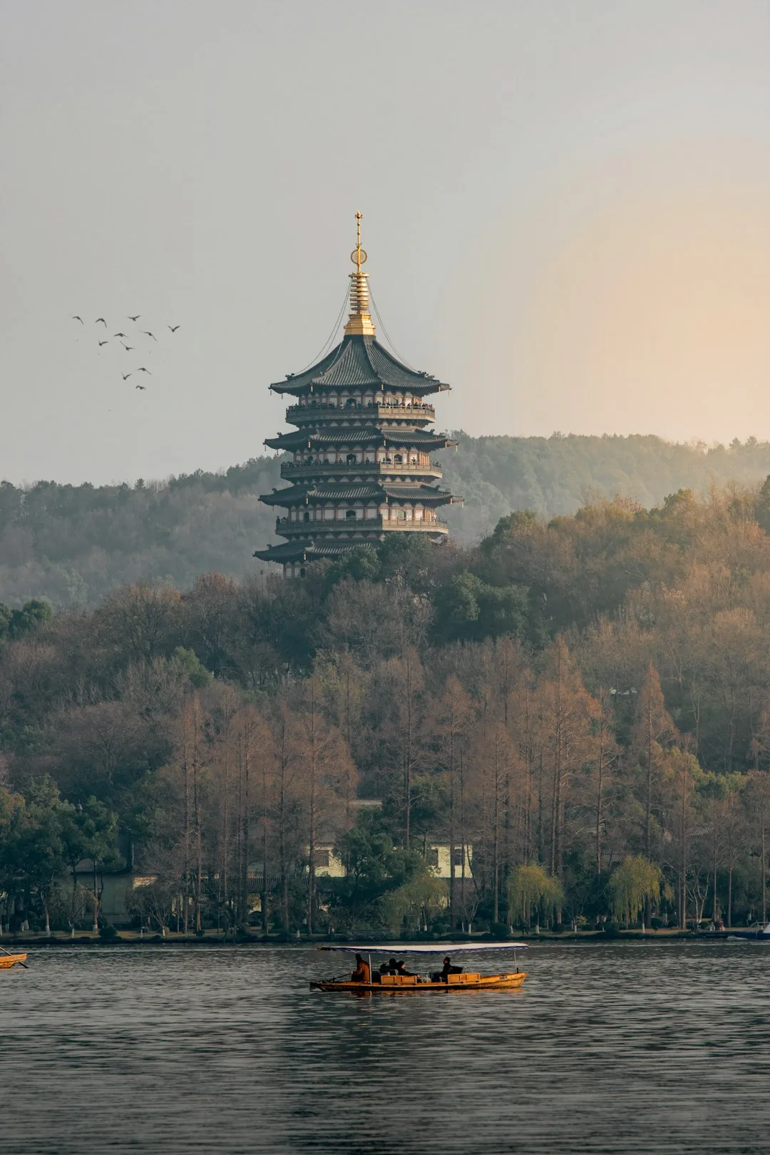 Leifeng Pagoda rising above trees beside West Lake in Hangzhou