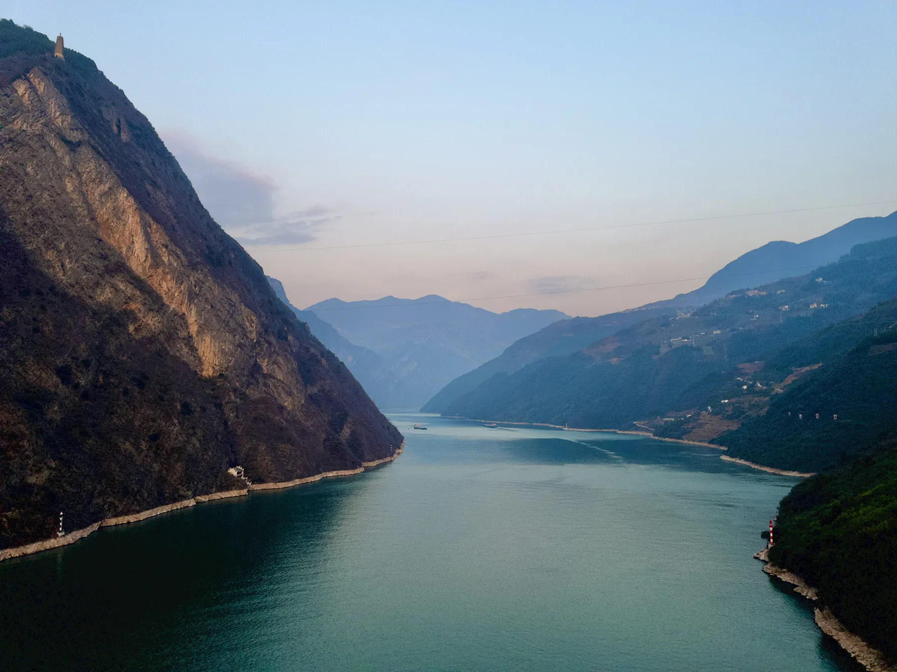 Steep green cliffs rising above the Yangtze River through the Three Gorges