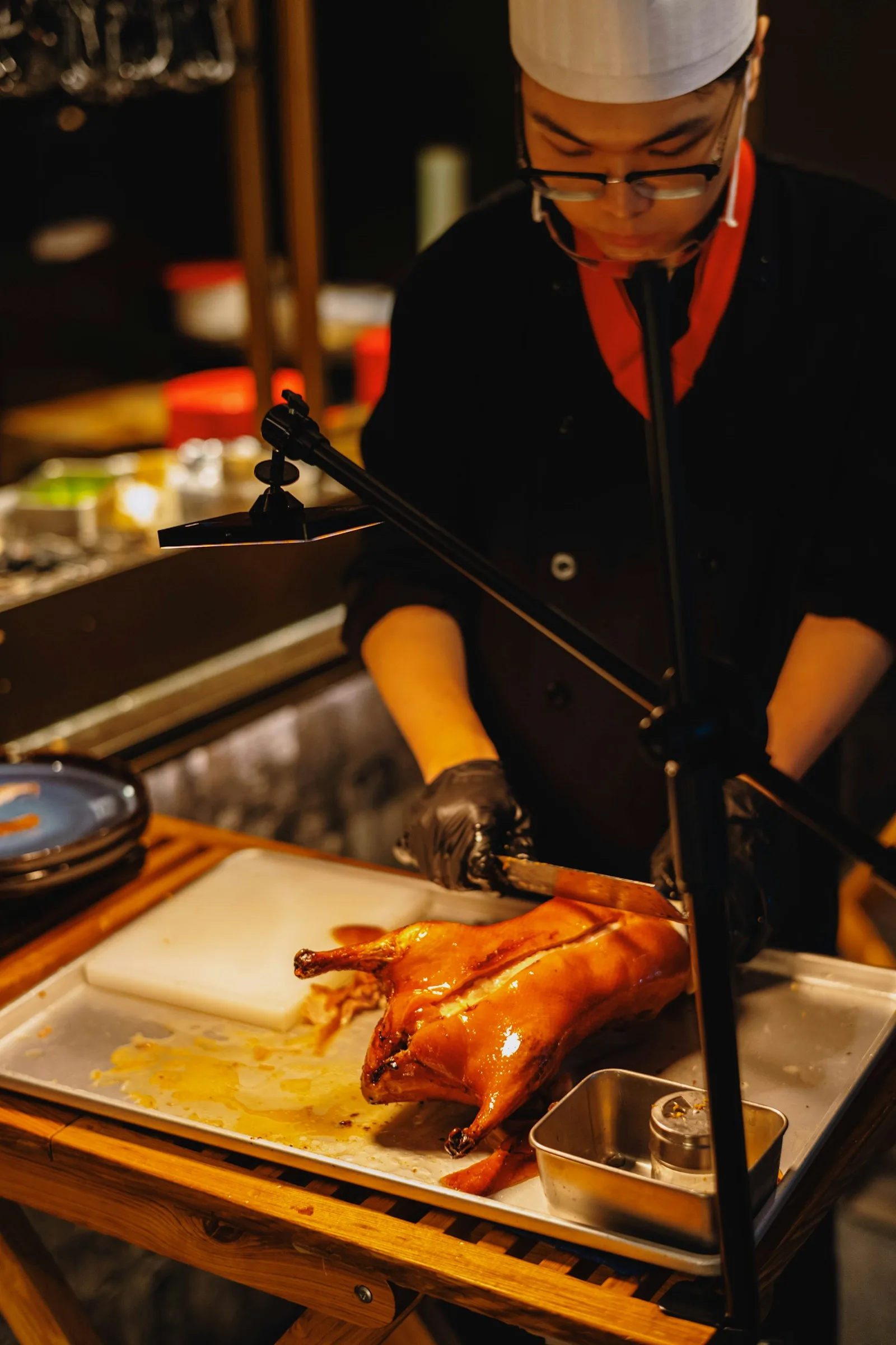 Peking duck being carved by a chef
