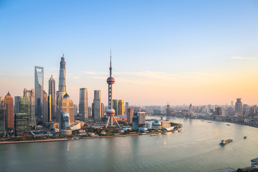 The Bund waterfront promenade at dusk, Pudong skyline in the background